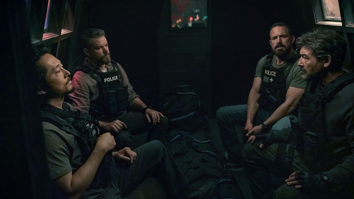 Cops sitting around money bags in The Rip