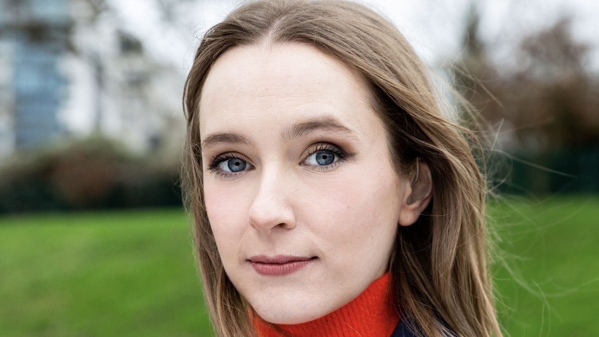 Rose Ayling-Ellis in an orange top stands outside for Rose Ayling-Ellis: Signs for Change.