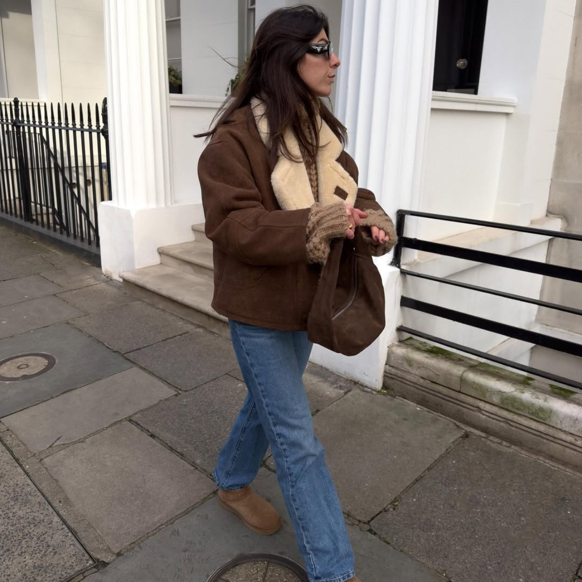 Influencer Francesca Saffari wearing straight leg jeans and Uggs. 