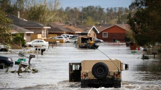 A National Guard vehicle drives through floodwater left behind by Hurricane Ida in LaPlace, Louisiana, U.S., on Monday, Aug. 30, 2021.