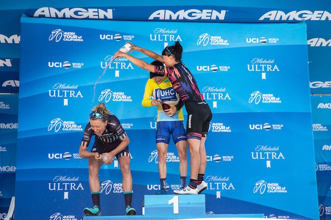 A celebratory drink for second-placed Tayler Wiles (Trek-Drops) from third-placed Kasia Niewiadoma (Canyon-SRAM)