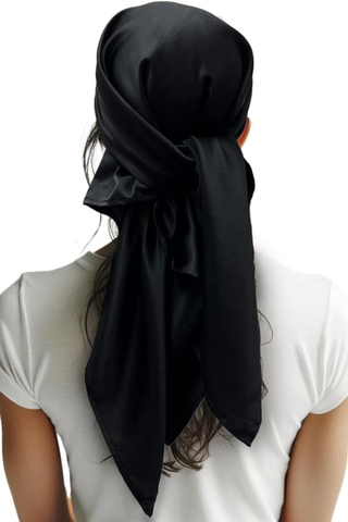 back of a woman's head wearing an open-style turban
