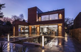 large brick clad self build with glass basement