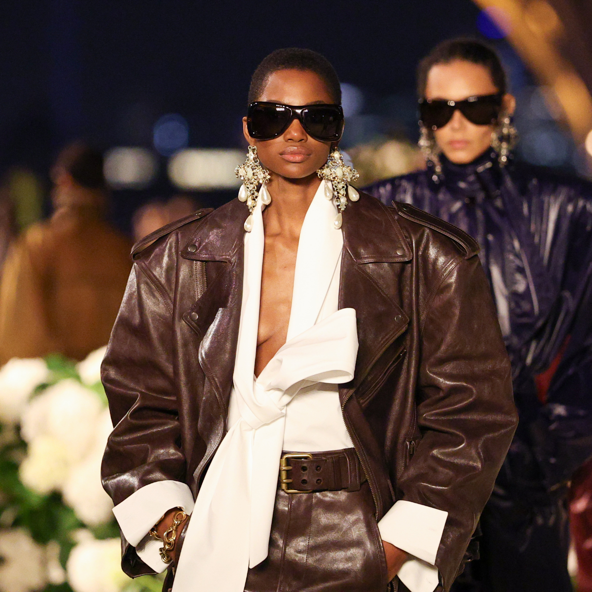 Three models walking the Saint Laurent catwalk in Paris