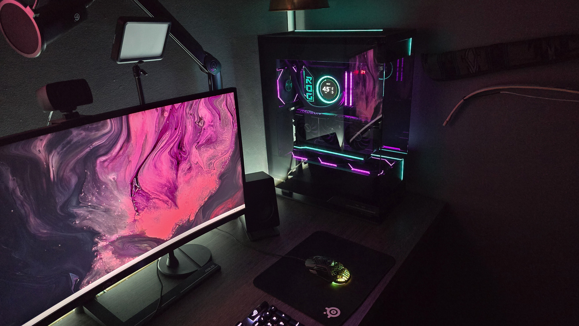 A gaming PC lit up with neon-style lighting and using an RX 9070 XT graphics card.