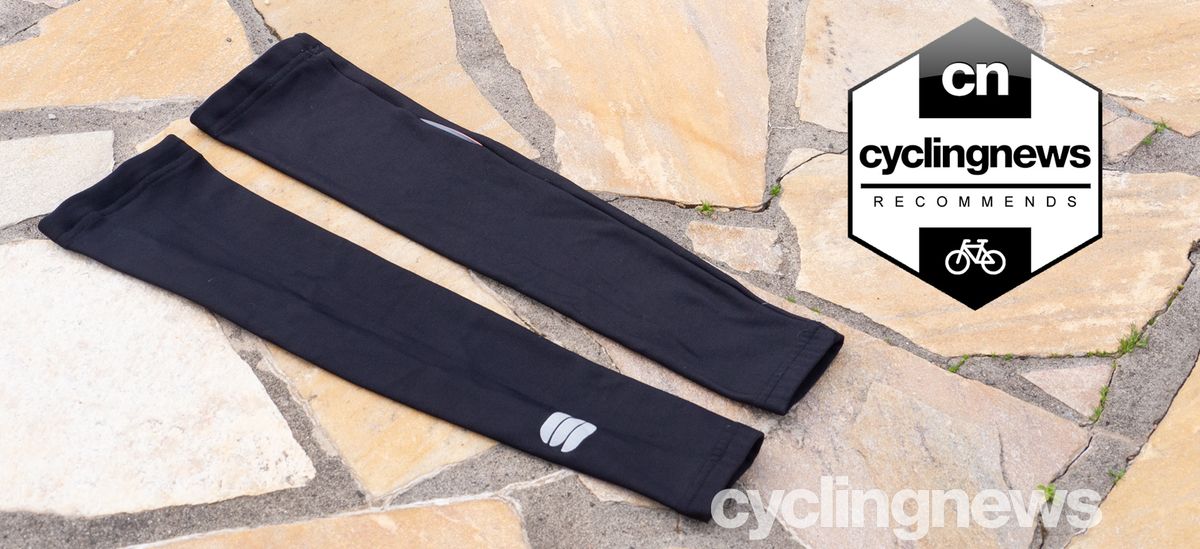 A pair of Sportful NoRain Arm warmers on a paved floor