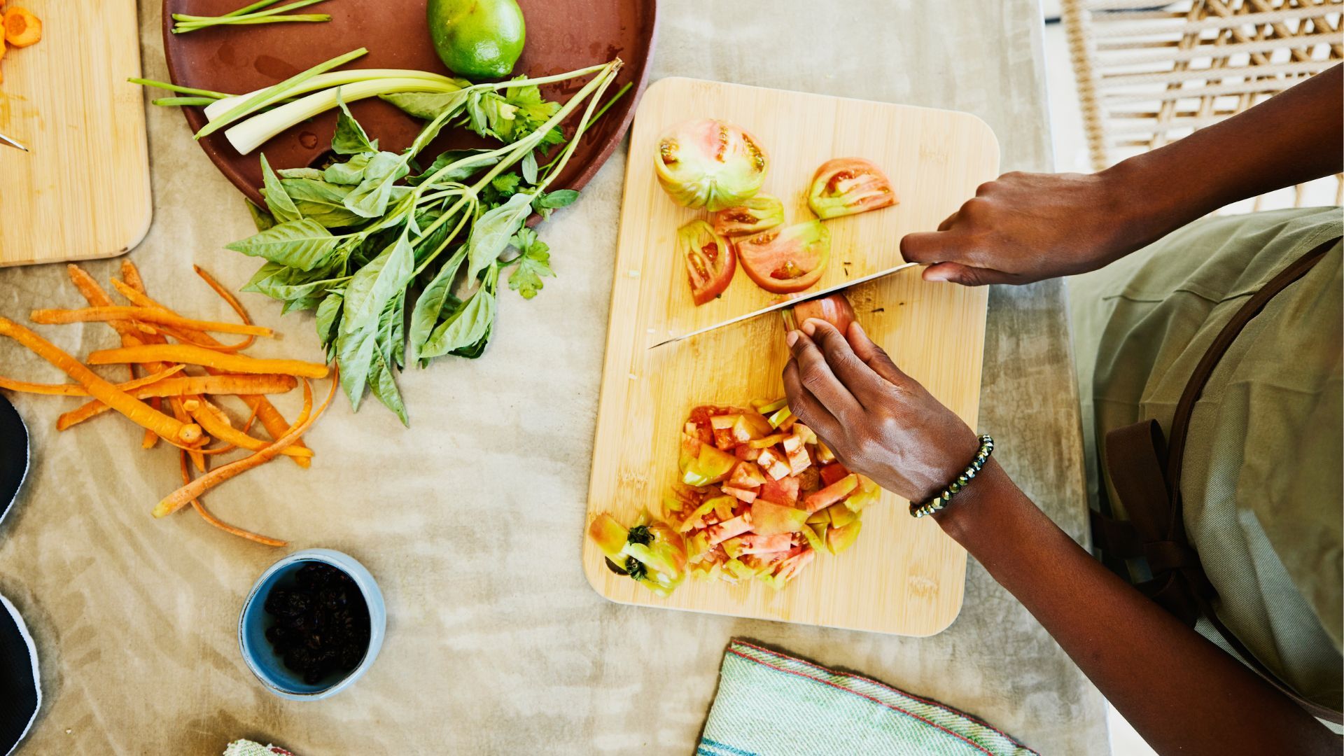 Cleaning a chopping board news piece - birdseye view of woman cooking