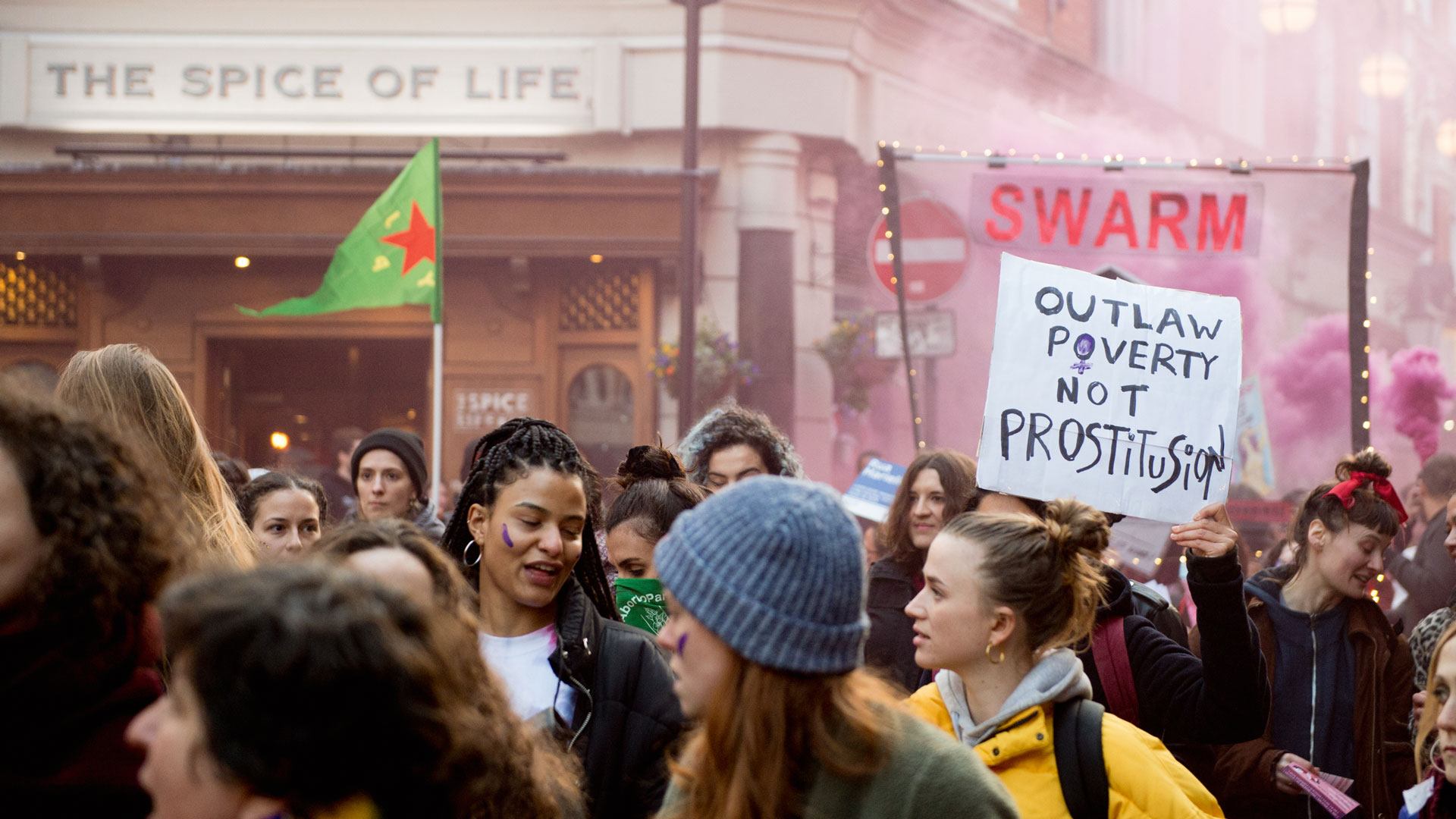 women protesting for sex workers rights in the street with signs