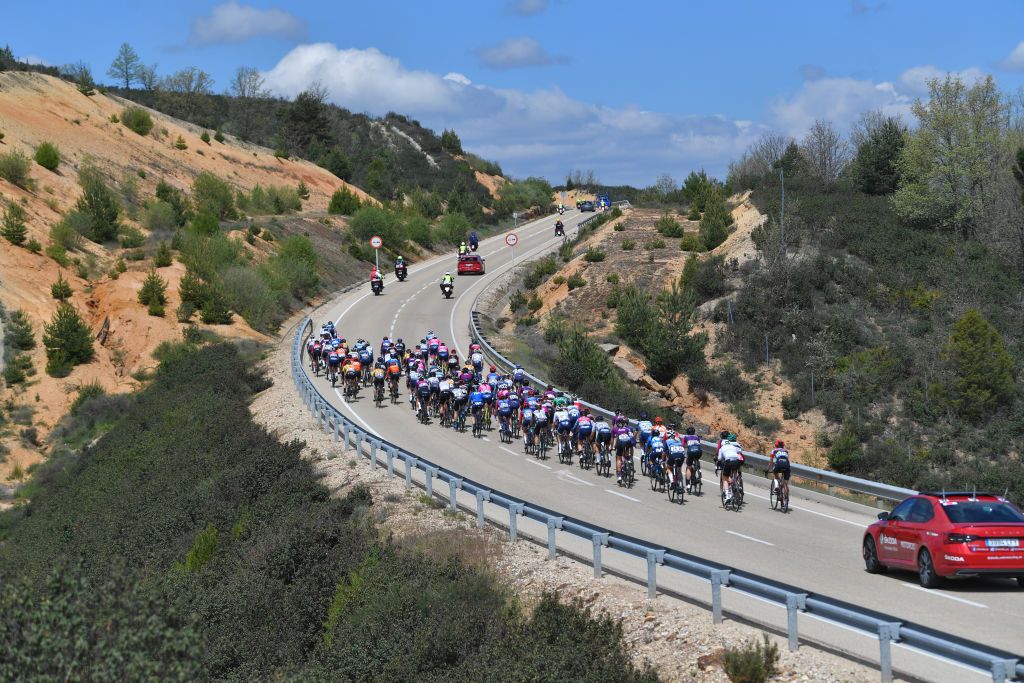 LAGUNAS DE NEILA SPAIN MAY 23 The Peloton passing through Palacios de la Sierra during the 6th Vuelta A Burgos Feminas 2021 Stage 4 a 1216km stage from Quintanar de la Sierra to Lagunas De Neila 1870m Landscape VueltaBurgos BurgosFem UCIWWT on May 23 2021 in Lagunas De Neila Spain Photo by Luc ClaessenGetty Images