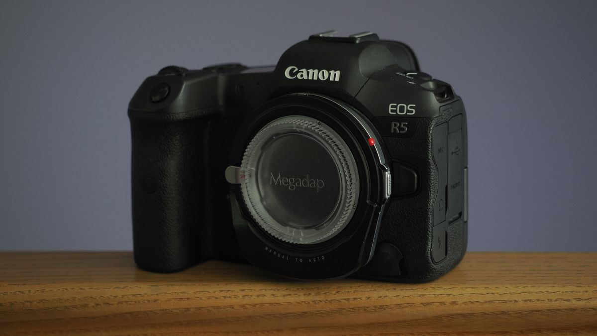 Megadap M2RF adapter mounted to a Canon EOS R5 on a wooden surface