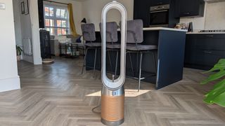 The Dyson Find+Follow Purifier Cool standing in someone's kitchen.
