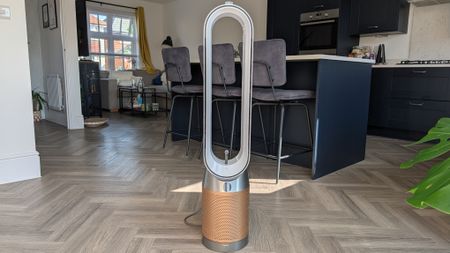 The Dyson Find+Follow Purifier Cool standing in someone's kitchen.