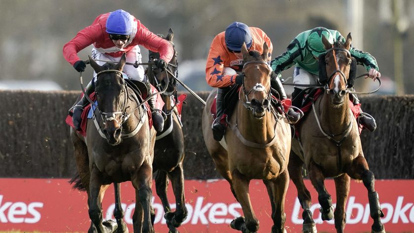 Three horses battle down the final straight in the King George VI Chase at Kempton Park.