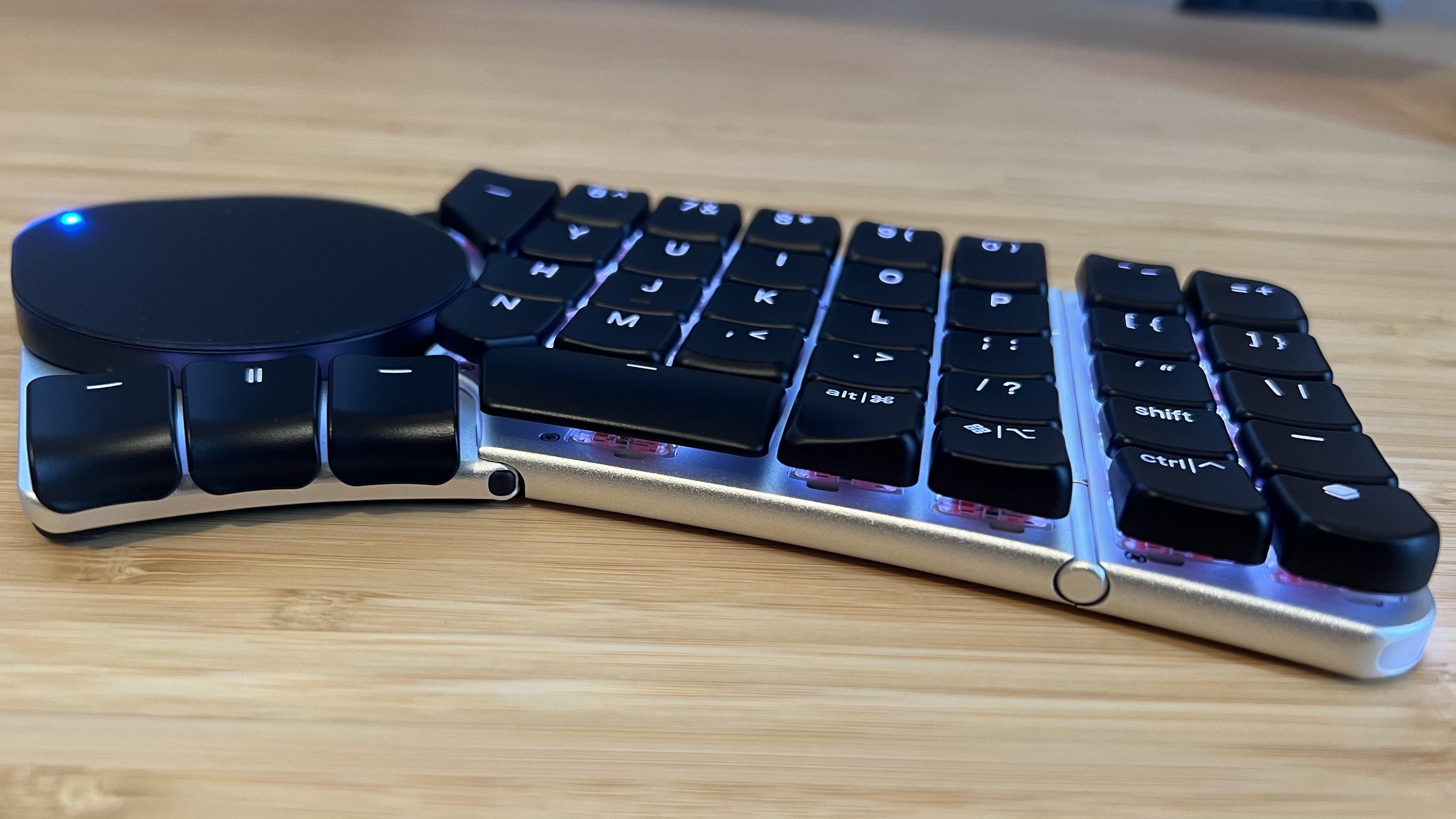 Right side of Naya Create keyboard with touchpad module installed on a wooden desk