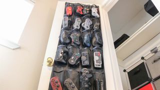 An over-the-door shoe rack used to hold gamepad controllers