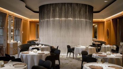 Alain Ducasse at The Dorchester main dining room with a curtain of optical fibres screening a special table