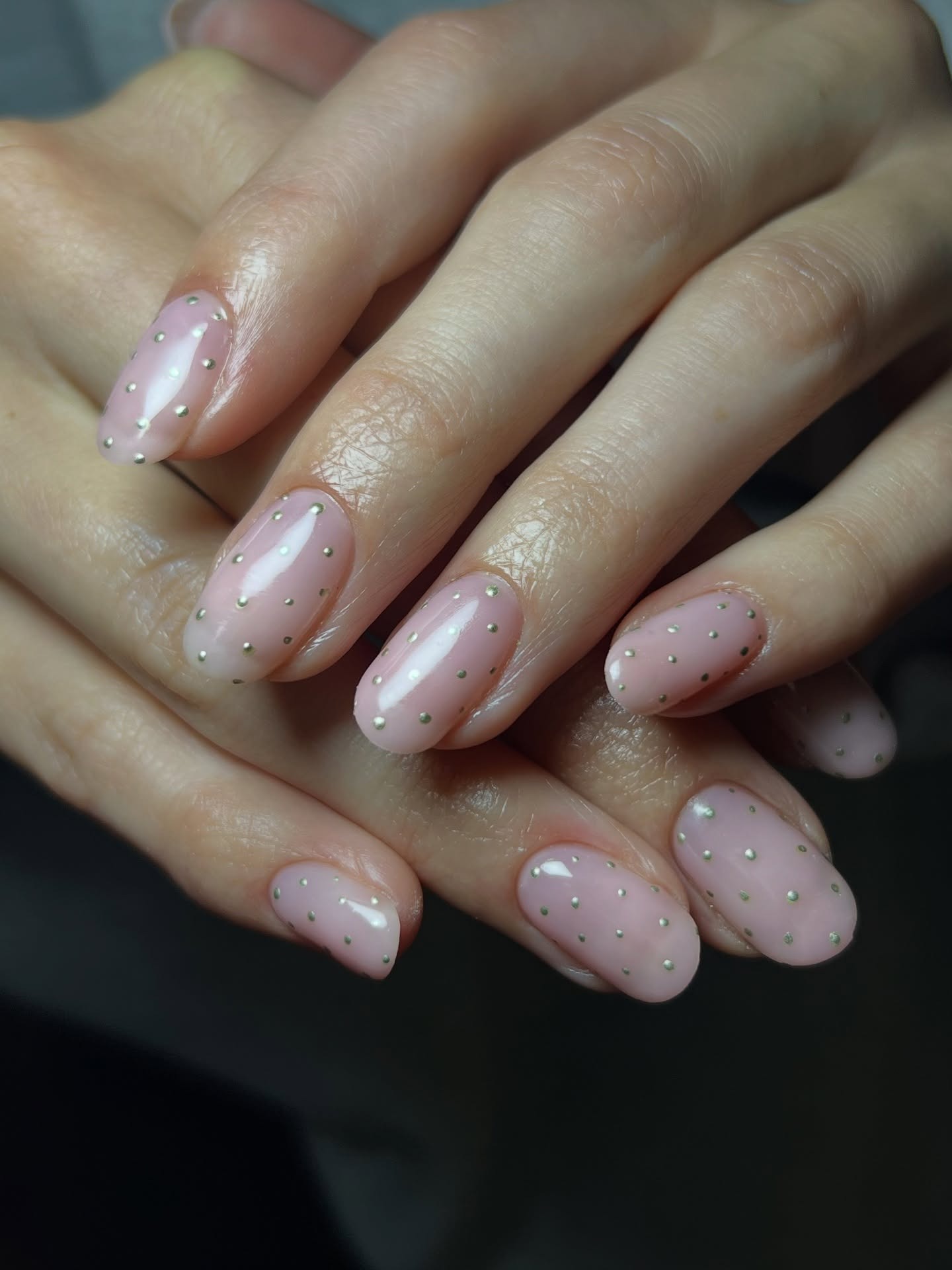 A gold polka dot manicure