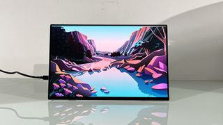 Testing the Acer ProDesigner PE160WUT in a home office next to a MacBook