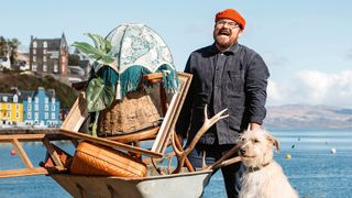 Banjo Beale, wearing red woolly hat and workmanlike denim jacket, carries a wheelbarrow filled with bric-a-brac alongside his faithful dog in BBC&#039;s Designing the Hebrides season 2 