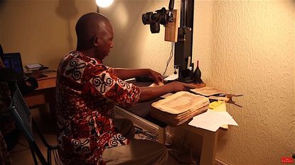 A Malian man makes digital copies of ancient Islamic manuscripts