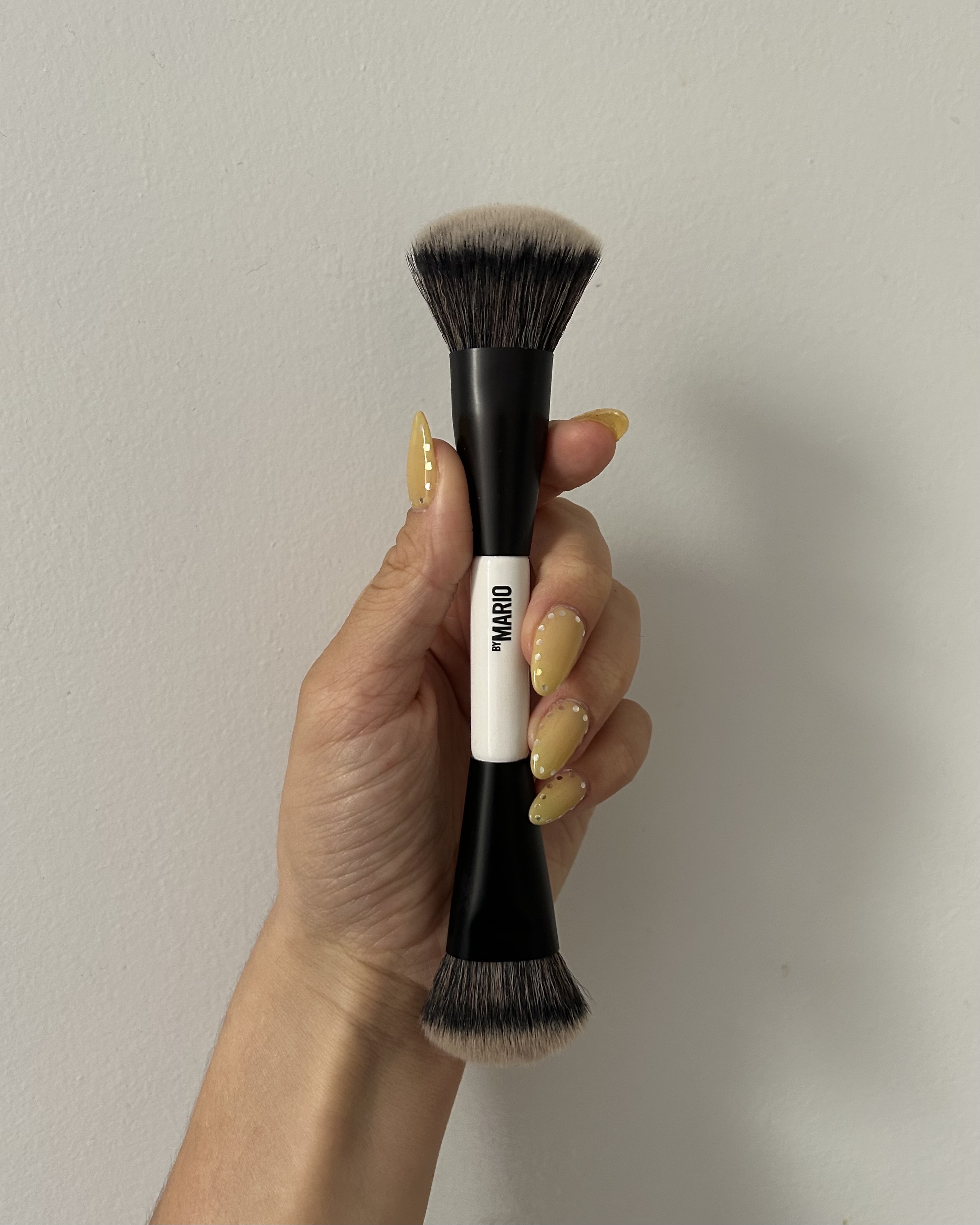 Alyssa Brascia holding the Makeup by Mario F4 Dual-Ended Foundation Brush.