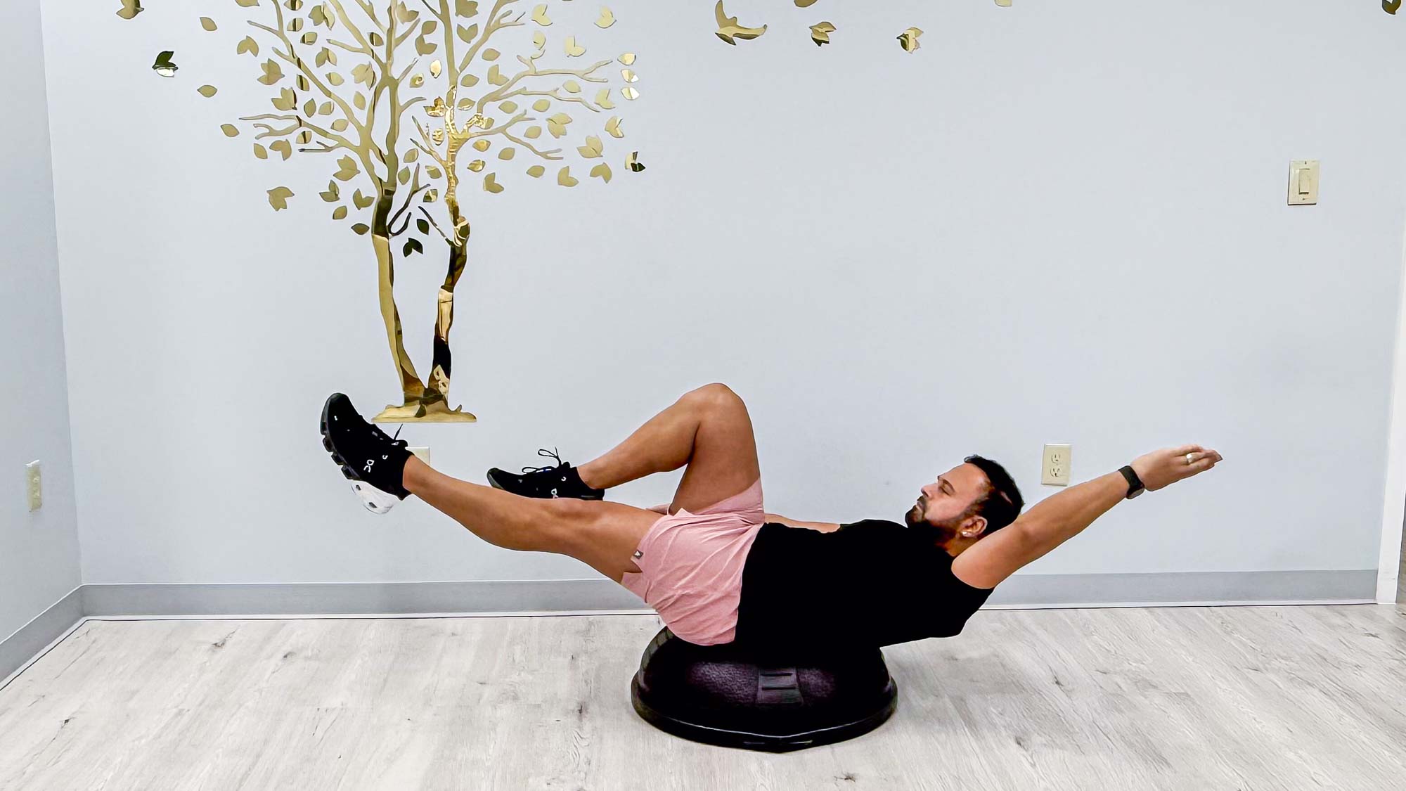 Nico Gonzalez performing the BOSU dead bug to stand exercise