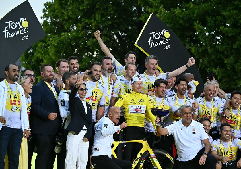 UAE Team Emirates - XRG team&#039;s Slovenian rider Tadej Pogacar wearing the overall leader&#039;s yellow jersey celebrates with team staff on the podium after the 21st and final stage of the 112th edition of the Tour de France cycling race, 132.3 km between Mantes-la-Ville and Paris Champs-Élysees, on July 27, 2025. (Photo by Loic VENANCE / AFP) (Photo by LOIC VENANCE/AFP via Getty Images)