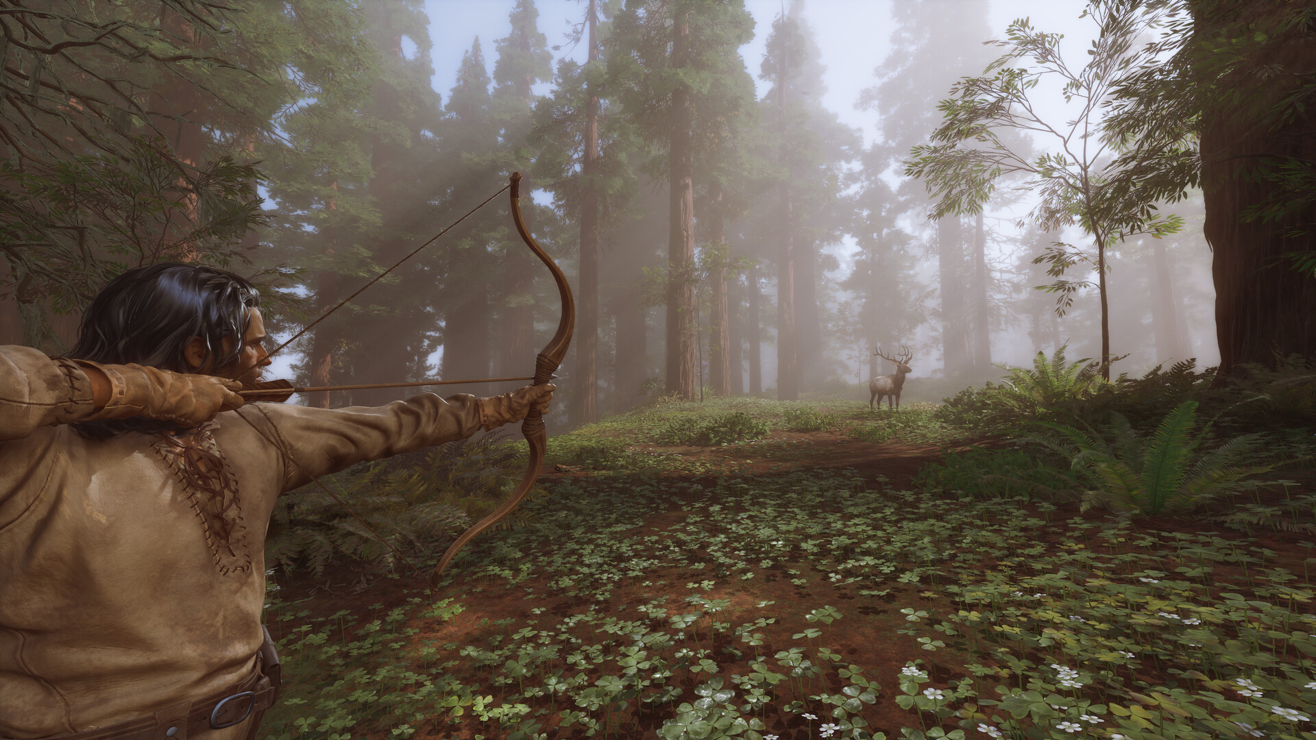 Long-haired man aims drawn bow toward deer standing at a distance in a foggy forest