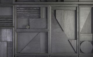 Sculptor Louise Nevelson was the inspiration for the black matte wooden wall