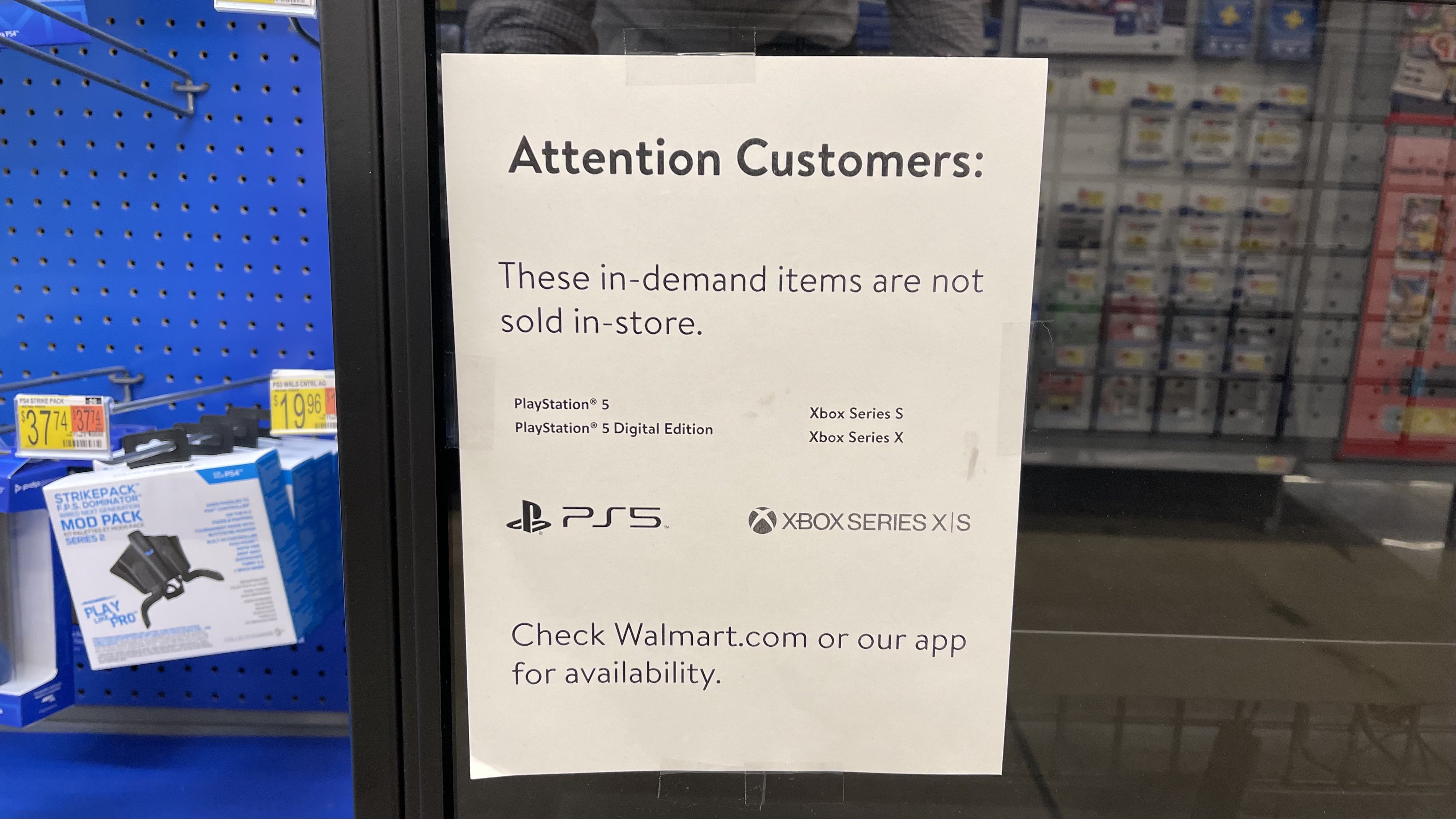 A printed sign at Walmart that tells customers PS5 and Xbox Series X are out of stock.