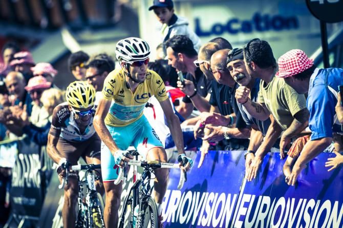 Vincezo Nibali from the Astana team rides the final metres to the finish line to Pla d'Adet and wasn't even rattled by the huge moustache in the sidelines. or is it just very long nose hair?