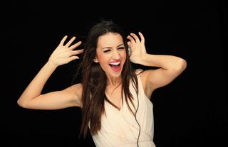 A happy woman wearing headphones.