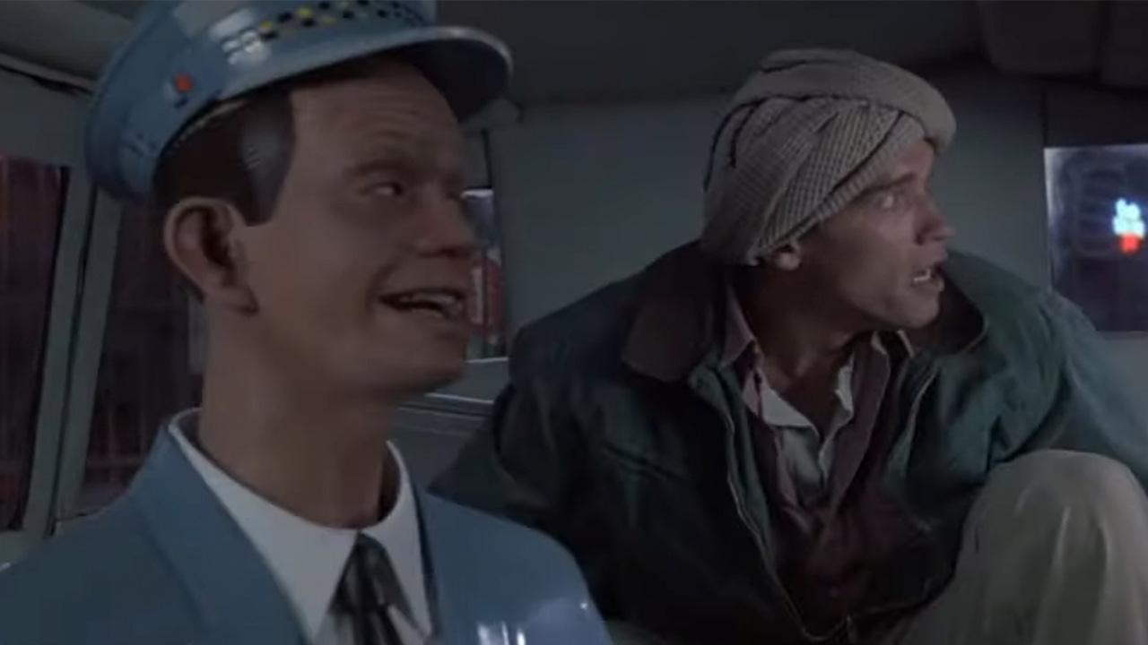 Arnold Schwarzenegger in the back of a cab driven by a robot in Total Recall