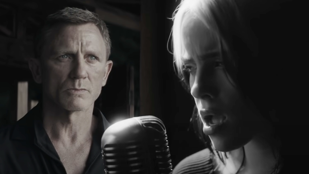 Daniel Craig scowls while Billie Eilish sings in the No Time To Die music video.