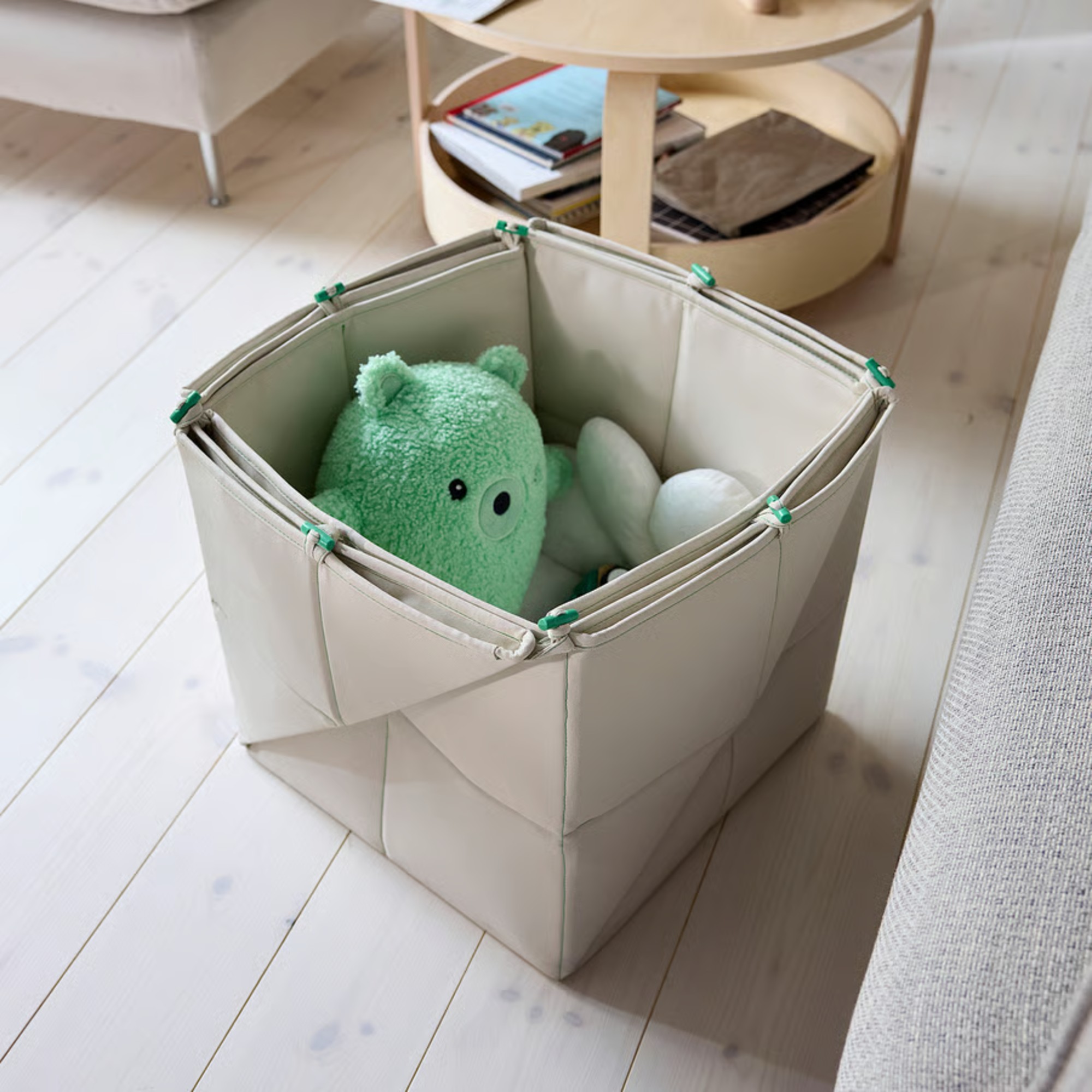 The IKEA GREJSIMOJS storage box in a living room with toys inside