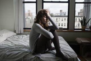 Lonely Woman in Bedroom - stock photo