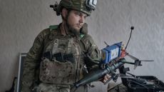 A soldier holds a drone