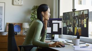 Businesswoman discussing during video conference. Multiracial male and female colleagues are attending online meeting. She is at home office.