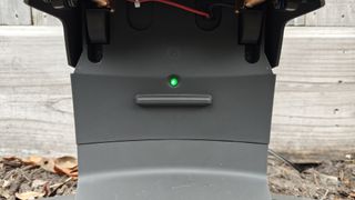 Green LED light on Automower 450XH charging pad indicating successful setup