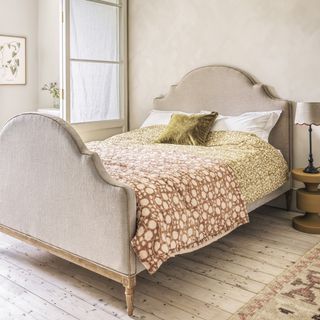 beige bedroom with wooden floors