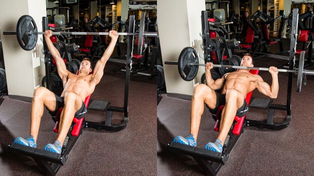 A man performing an incline bench press as part of a workout plan for muscle gain