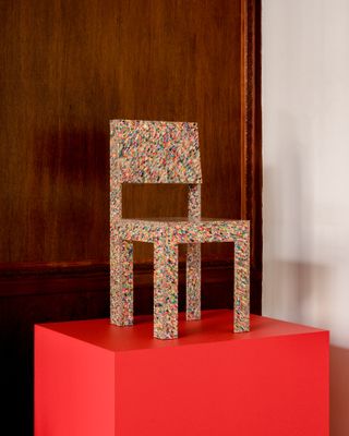 Multi coloured chair on red block