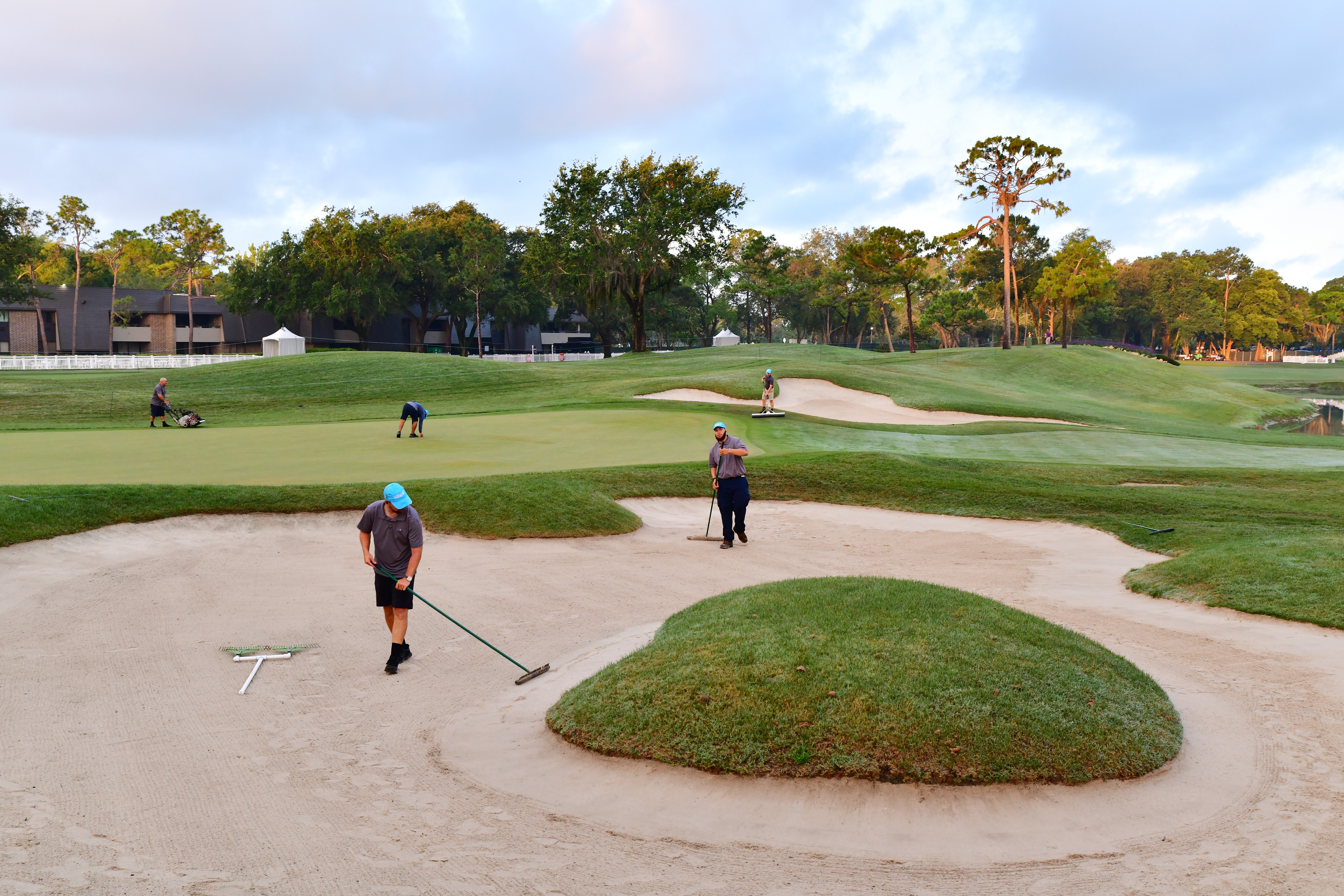 Ground staff tend to bunkers at the Valspar Championship