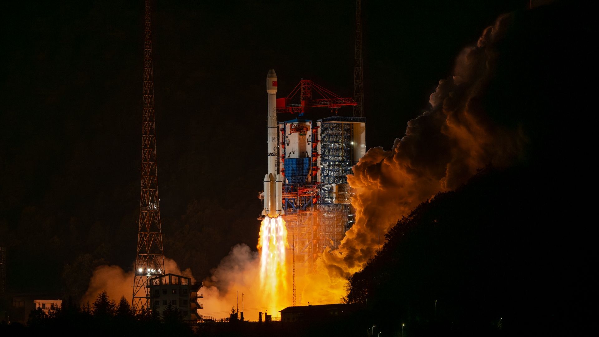Photo of a Long March-3B rocket lifting off from a site in China at night