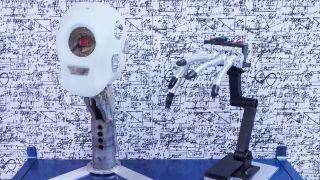 A robot with a camera in its head and a hand with fingers