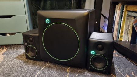 The Mackie CR3.5BT speakers next to the Mackie CR8SBT subwoofer on a carpeted floor. 