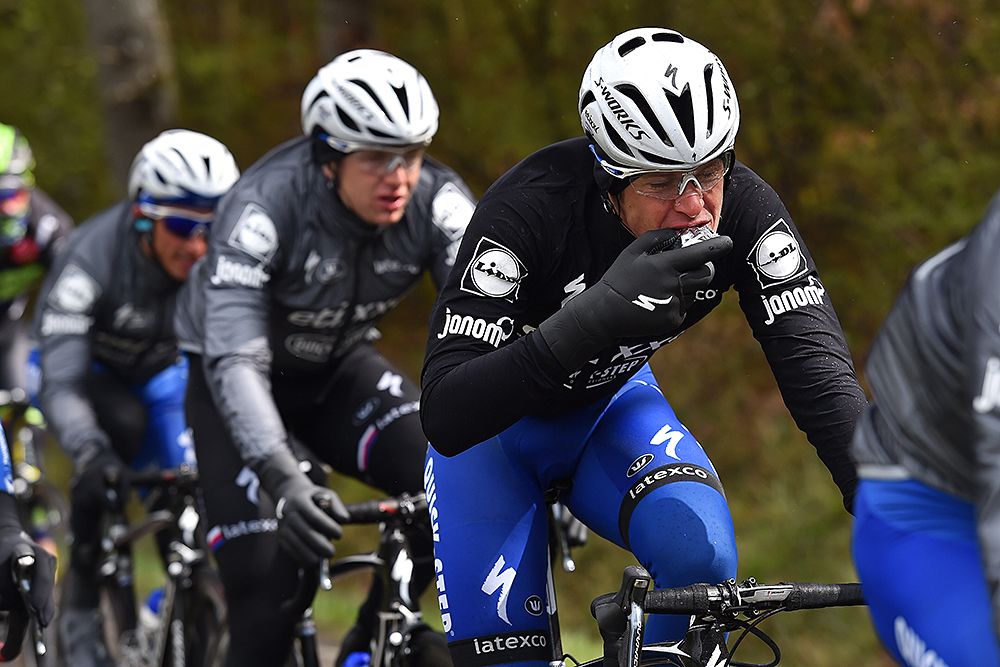 Maxim Bouet tries to eat some food at Liege-Bastogne-Liege