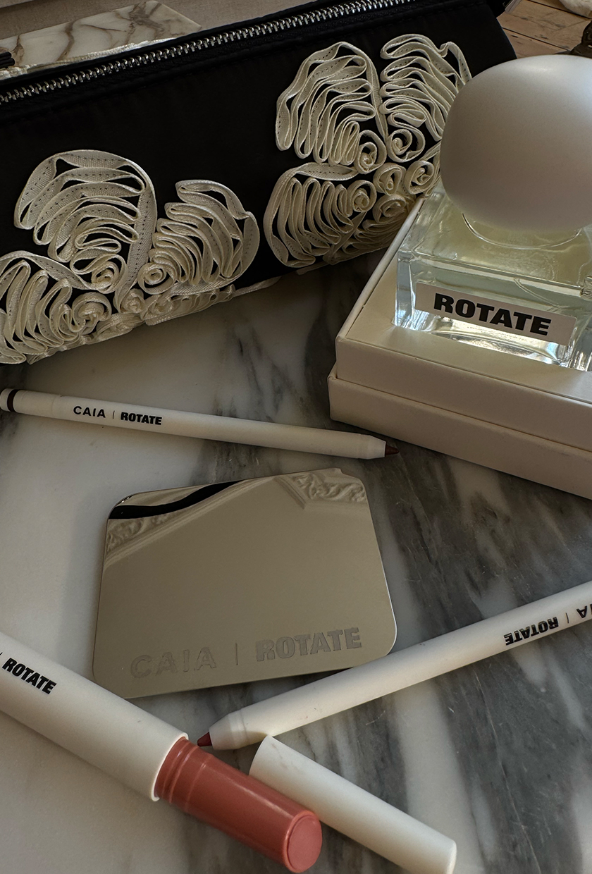 A flatlay of Caia x Rotate makeup products and perfume