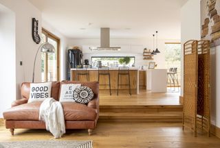 large kitchen and sitting room with wood floor