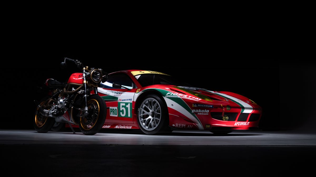 A red Ferrari in a studio against a black background